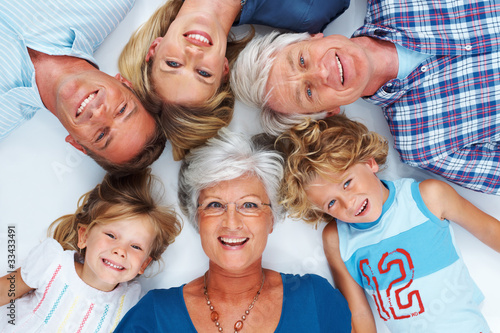 Photo: Multi generation family lying down together Multi generation family lying down together