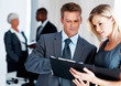 Male and female executive reviewing document