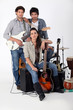 A rock band posing with their instruments