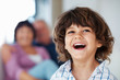 Cheerful boy with grandparents in background