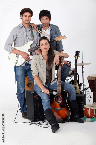 Photo: A rock band posing with their instruments A rock band posing with their instruments