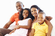 Couple sitting on couch with two kids