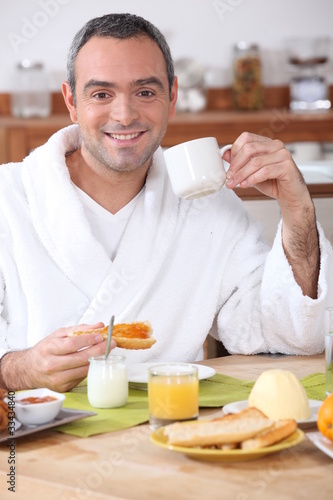 Photo: Man having breakfast in dressing gown Man having breakfast in dressing gown