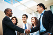 Photo: Mixed race business people shaking hands Mixed race business people shaking hands