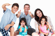 Enthusiastic family giving thumbs up on white background