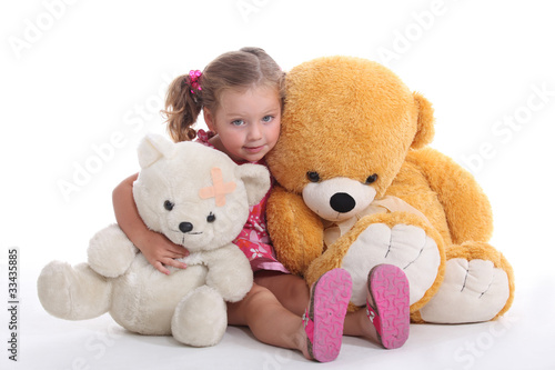 Photo: Little girl hugging two big teddy bears Little girl hugging two big teddy bears