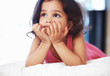 Closeup of adorable little girl in deep thought lying down Closeup of adorable little girl in deep thought lying down