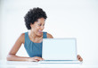 Sales woman displaying laptop