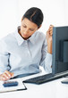 Female executive calculating bill Female executive calculating bill