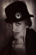 woman with painted mustache in hat
