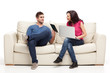 young couple relaxing with laptop book