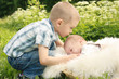 Cute little boy kissing brother outside