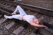 The girl lies on the rail tracks