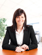 Smiling businesswoman sitting in her office