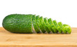 Sliced cucumber on chopping board isolated on white Sliced cucumber on chopping board isolated on white
