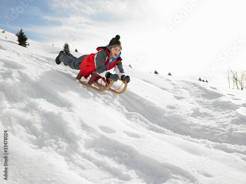 Photo: Pre-teen Boy On A Sled In The Snow Pre-teen Boy On A Sled In The Snow