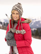 Young Woman holding Skis In Alpine Landscape