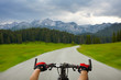 Man with bicycle riding mountain road