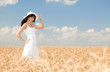 Young woman in golden wheat