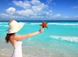 beach hat woman starfish in hand tropical Caribbean beach hat woman starfish in hand tropical Caribbean