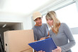 Woman with delivery man checking order contract