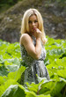 Woman standing among green vegetation