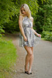 Woman with a dress along a road in a park