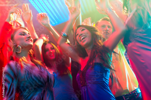 Photo: Party people dancing in disco or club Party people dancing in disco or club