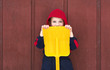 Young boy hides behind toy shovel Young boy hides behind toy shovel