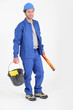 Builder holding bucket and spirit level.