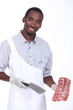 Butcher holding a rack of ribs
