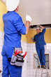 Electricians wiring a large room