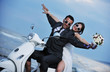 just married couple on the beach ride white scooter