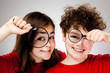 Girl and boy holding magnifying glass Girl and boy holding magnifying glass