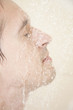 young adult man fashing face in shower