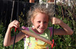 Photo: joyful girl playing in the yard joyful girl playing in the yard