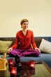 Happy girl sitting in lotus pose