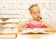 Little schoolgirl reading a book