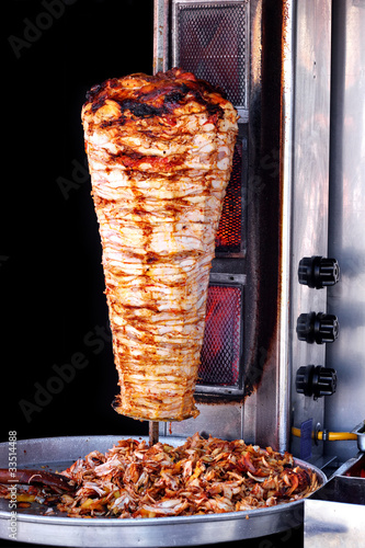 Photo: Doner kebab with tray of sliced meat Doner kebab with tray of sliced meat