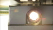 Front view of 8mm film projector lens in action.