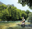 Foto: A young fisherman fishing on a riverTreska A young fisherman fishing on a riverTreska