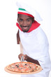 Man serving a pizza on a wooden peel (board)