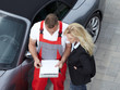Master mechanic explaining maintenance costs outdoors