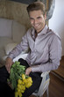 Handsome young man holding flowers