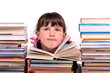 Portrait of thoughtful girl sitting among stacks of books