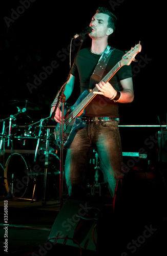 Photo: Electric bass-guitar player Electric bass-guitar player