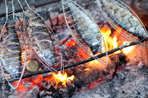 Photo: Grilling fish on campfire Grilling fish on campfire