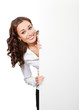Smiling businesswoman showing blank signboard, isolated