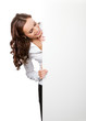 Smiling businesswoman showing blank signboard, isolated