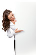 Smiling businesswoman showing blank signboard, isolated